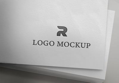 纸上的银色logo标志样机模型